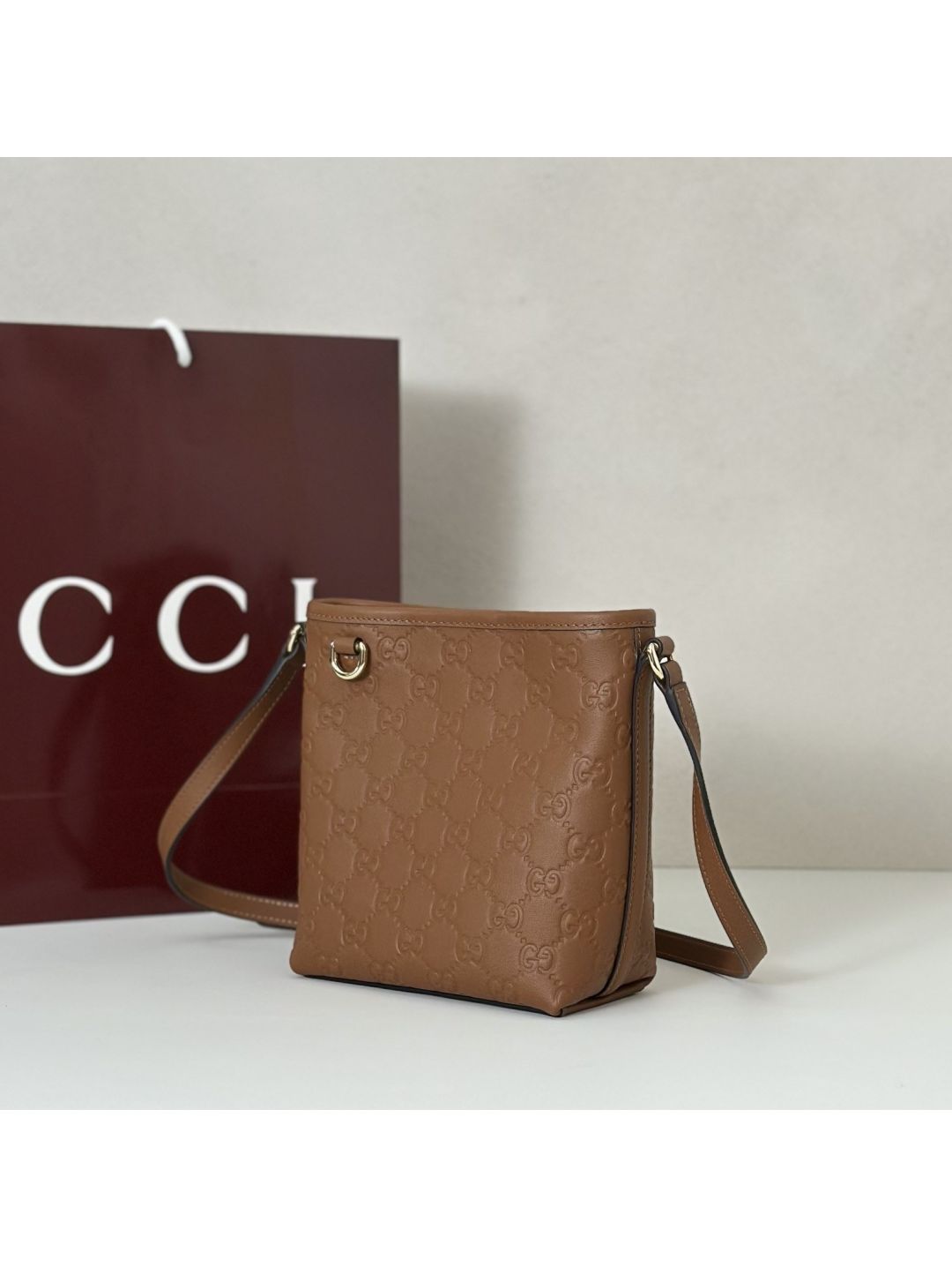 gg-embossed-crossbody-bag-in-tan-rxgui292540-01