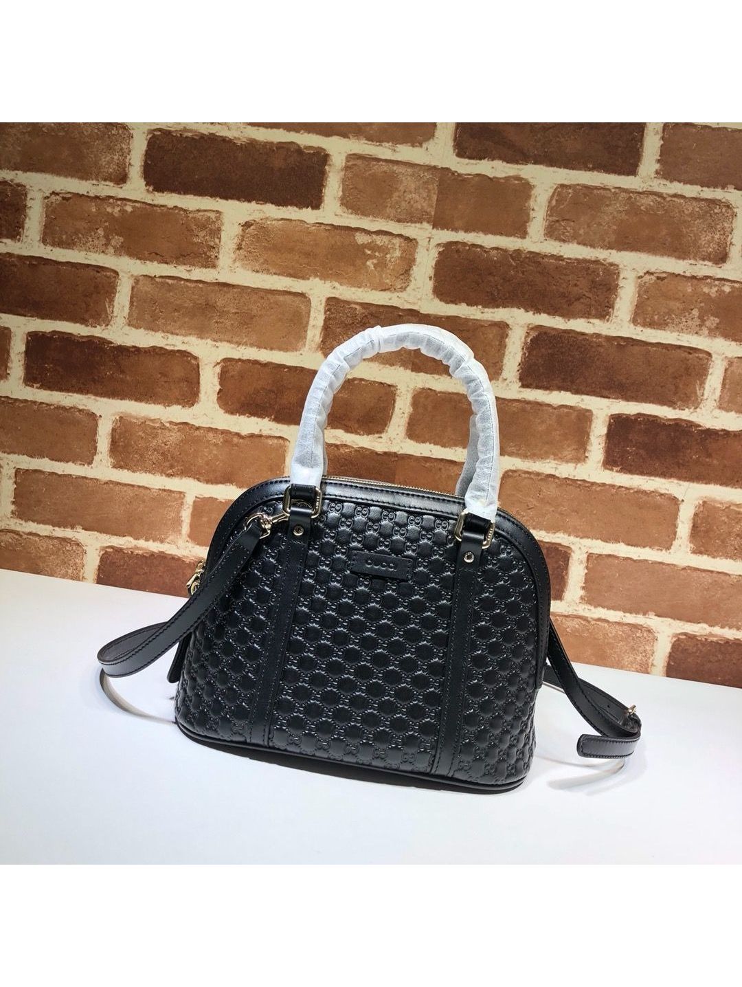 gg-embossed-dome-shoulder-bag-in-black-rxgui292556-01