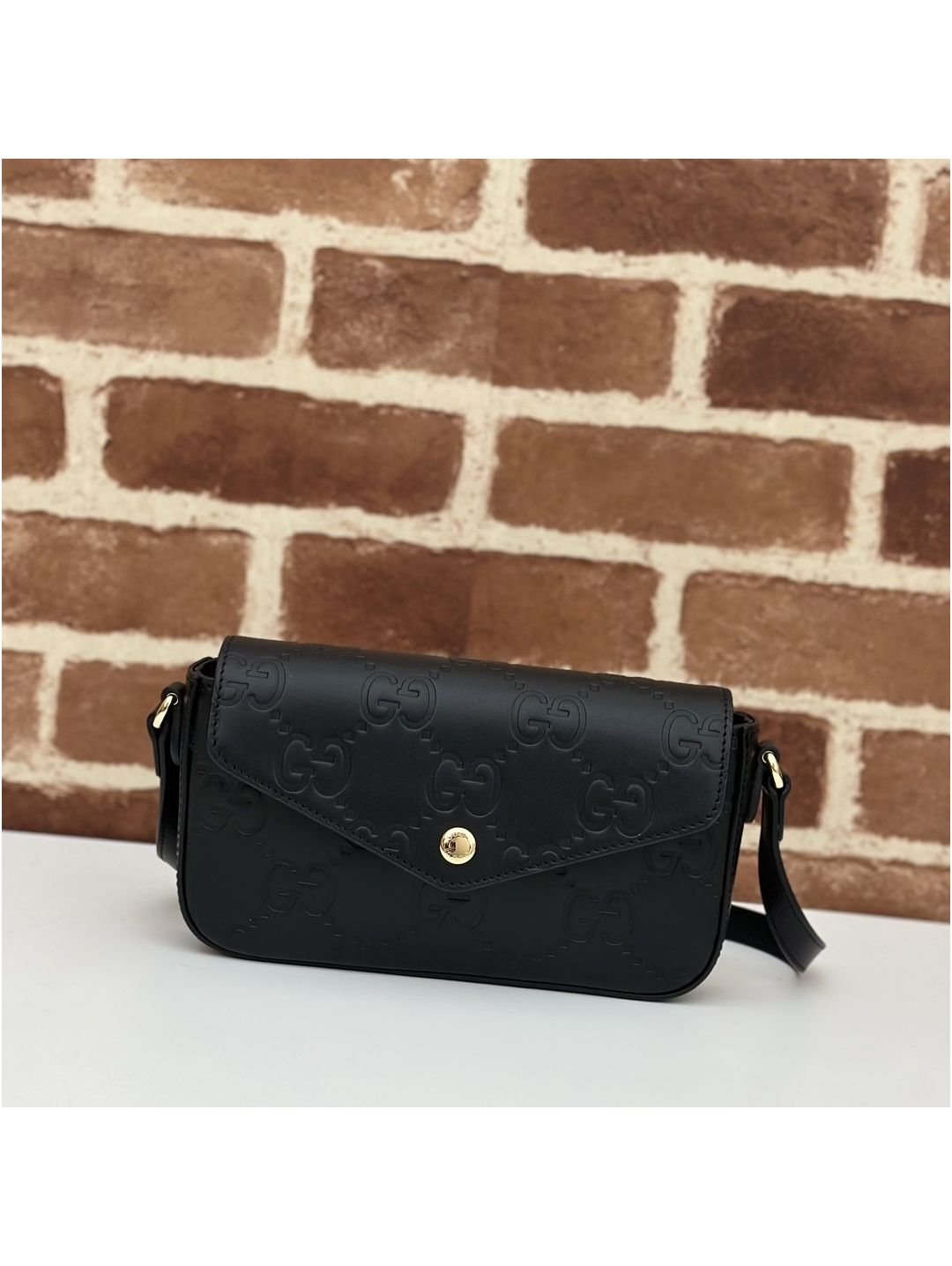 gg-embossed-flap-crossbody-bag-in-black-rxgui292566-01