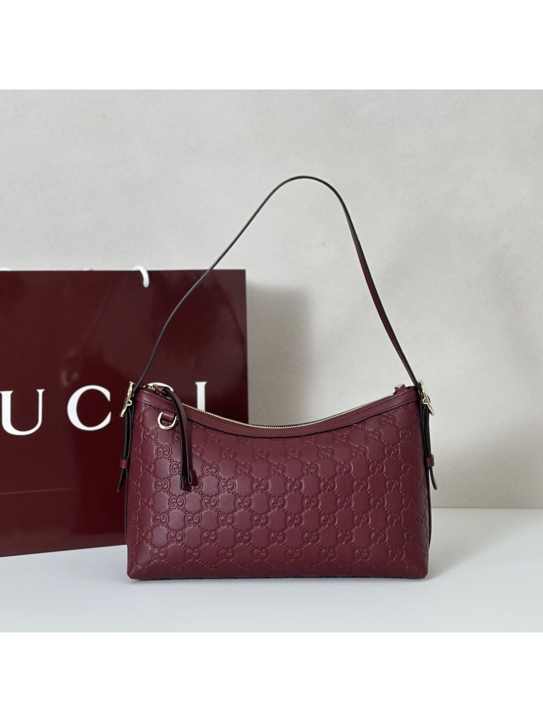 gg-embossed-shoulder-bag-in-burgundy-rxgui292403-01