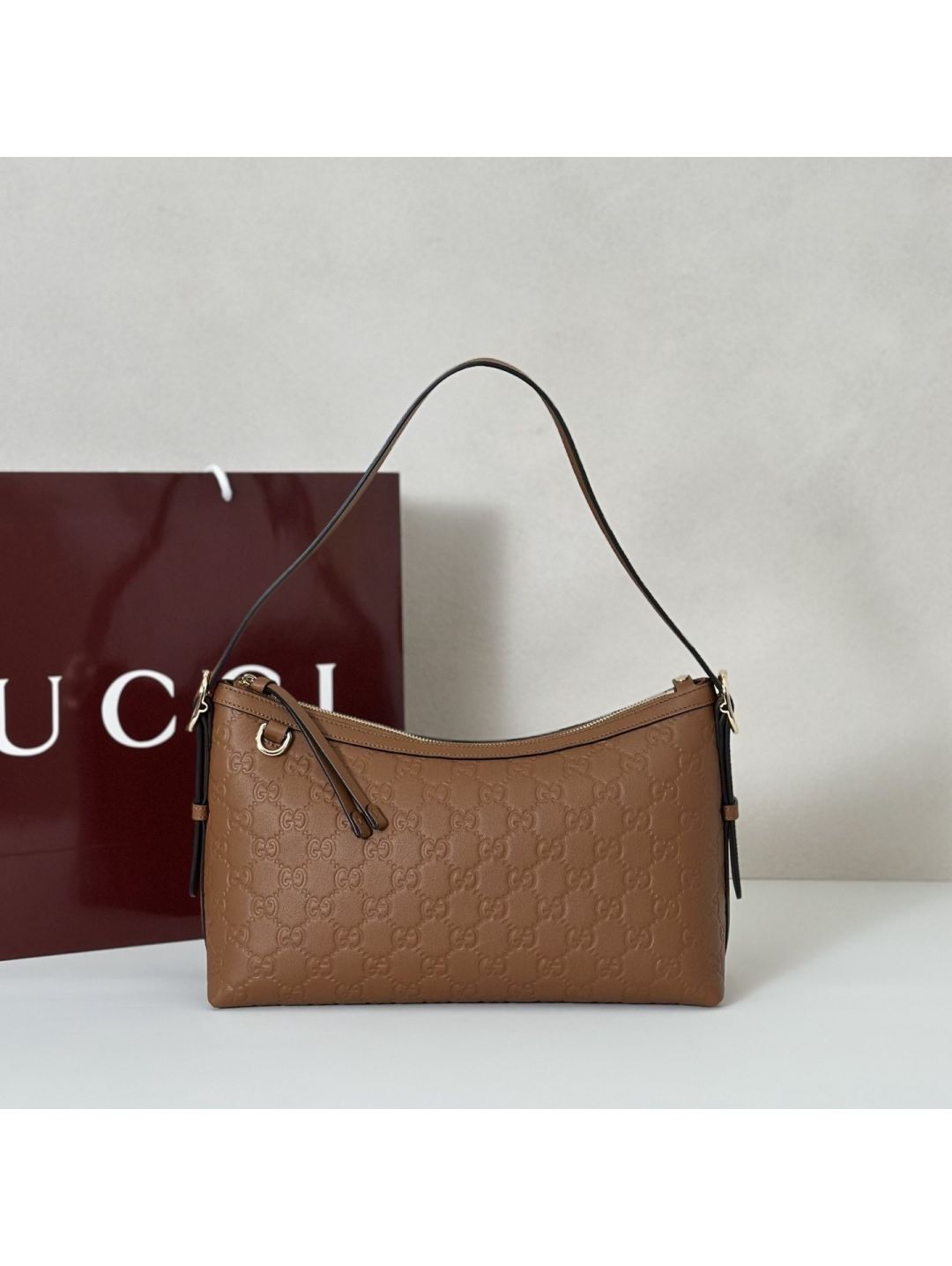 gg-embossed-shoulder-bag-in-tan-rxgui292404-01
