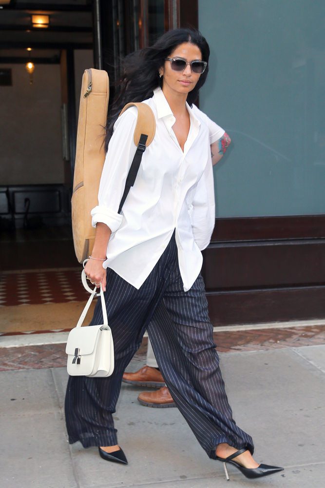 Camila Alves in an oversized white shirt carrying a white Celine Classic Box bag