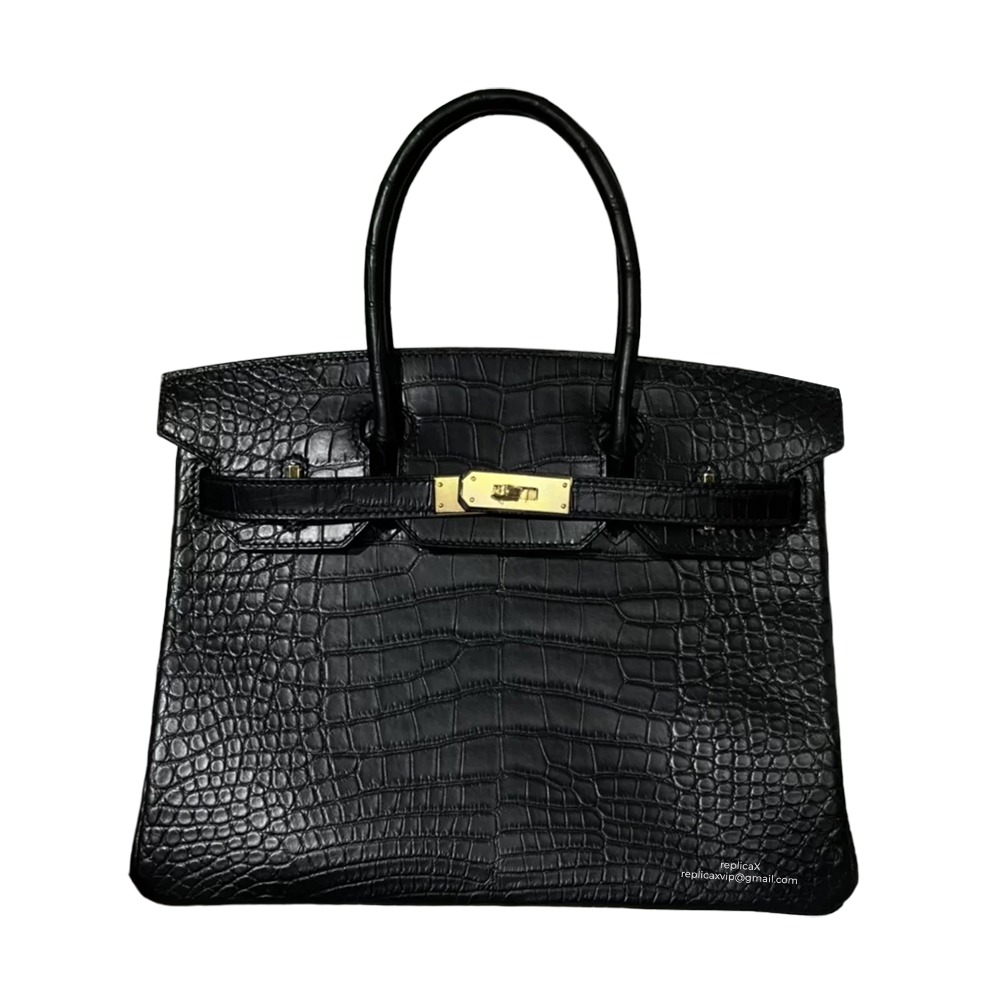 Front view of a black Hermès Birkin 30 top-handle bag with upright proportions